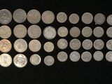 a lot of coins that are on a black surface