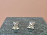 pair of diamond stud earrings on a marble block
