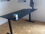a desk with a computer on it in a room