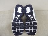nike air max running shoes on a couch with white and black soles