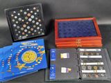 several different types of coins are displayed in a display case