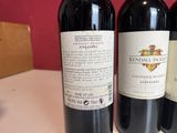 three bottles of wine sitting on a table next to each other