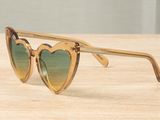 the sunglasses are made of plastic and have a heart shaped frame