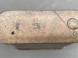 a small metal object with a number on it