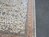 a large rug on the floor next to a chair