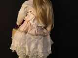 a doll that is standing next to a pair of shoes