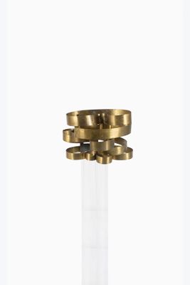 brass and clear glass candle holder with four rings on the top