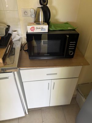 a microwave and a toaster sitting on a counter in a kitchen