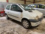 une petite voiture blanche garée dans un garage à côté d'autres voitures