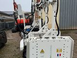 a machine that is sitting on the ground in front of a building