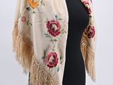 an image of a woman wearing a shawl with flowers on it