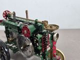 a small model of a tractor with gears on it