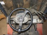 a steering wheel on a forklift in a garage