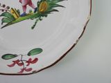 a plate with a bird painted on it on a wall