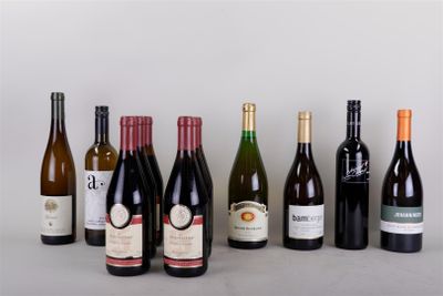 bottles of wine are lined up in a row on a table