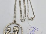 a silver necklace with a picture of a woman holding a child