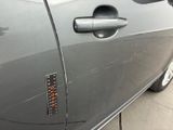 a close up of a car door handle with a sticker on it
