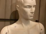 a mannequin of a man with tattoos on his chest
