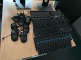 a keyboard and headphones on a desk with a computer monitor