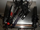 a table with a bunch of hair dryers on top of it