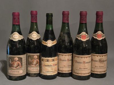 several bottles of wine are lined up on a table