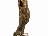 statue of a woman holding a book on a pedestal