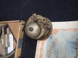 a small metal object sitting on top of a piece of paper