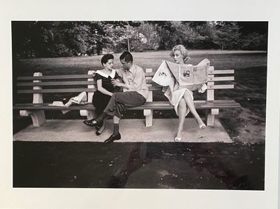 black and white photograph of two women sitting on a park bench