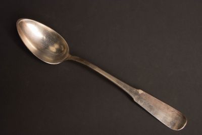 a spoon that is sitting on a black surface