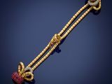 a gold, diamond and ruby necklace with a knot