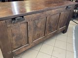 a large wooden chest sitting on the floor in a room