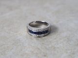 an image of a wedding ring with blue and white stones