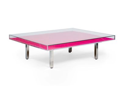 a pink coffee table with a glass top and metal legs