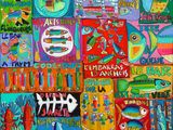 colorful paintings of fish and other things are displayed on a wall