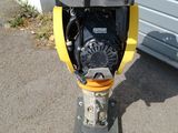 a yellow and black fire hydrant on the sidewalk