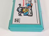 a blue box with a game on it sitting on a white surface