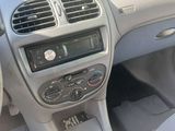 a dashboard of a car with a clock and a steering wheel