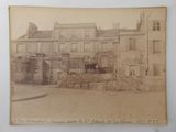 an old photo of a building with a horse in front of it