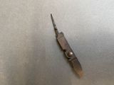a small knife that is laying on a table