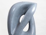 sculpture of a gray abstract sculpture on a white pedestal