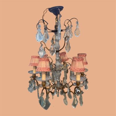 a chandelier made of glass with pink shades on it