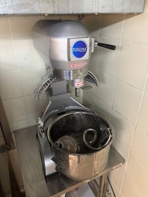 a mixer that is sitting on a stand in a kitchen