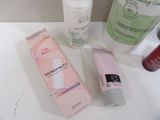 a bottle of lotion, a tube of lotion, and a tube of lotion on a counter