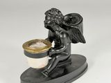 an image of a statue of a cup of coffee with an angel on it