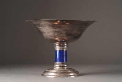 a silver cup with a blue handle sitting on a table
