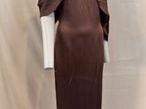 an image of a mannequin with a brown dress on a mannequin stand