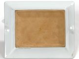a white plate with a brown square on it