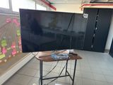 a flat screen tv sitting on a stand in a room