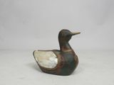 antique wooden duck figurine with mother of pearl in its beak