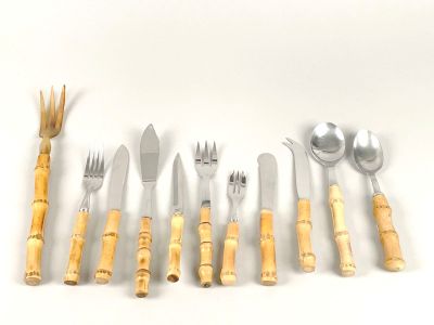 many different types of silverware on a white surface